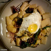 Rigatoni with zucchini, onions, beet greens, and ricotta topped with a sunny side up fried egg and padron peppers